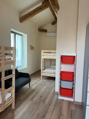 a small room with bunk beds and a couch at Charming Master House with Private Pool in Quarante