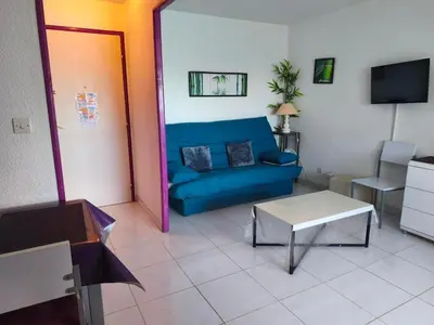 a living room with a couch and a table at Appartement T2 Confortable, 4/5 Pers, Plage Grazel, Parking Privé - FR-1-796-86 in Gruissan