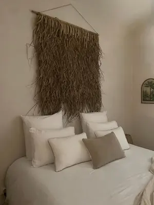 a bunch of pillows sitting on a bed at La Villa Lova - Loveroom avec spa privatif à Pamiers in Pamiers