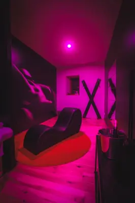 a bedroom with a bed with pink lights on it at La Villa Lova - Loveroom avec spa privatif à Pamiers in Pamiers