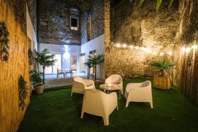 a room with chairs and a table and some plants at La Villa Lova - Loveroom avec spa privatif à Pamiers in Pamiers
