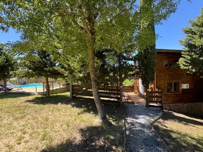 a house with a fence and a tree in the yard at Oyana in Montgradail