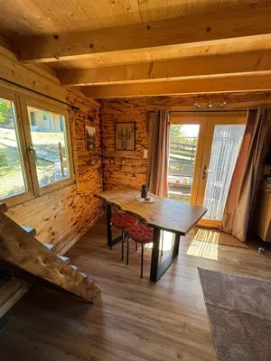 a wooden room with a wooden table in a cabin at Oyana in Montgradail
