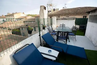 a balcony with blue chairs and a table on a patio at Magnifique T4- toit terrasse-Cosy-Centre ville-AA in Carcassonne