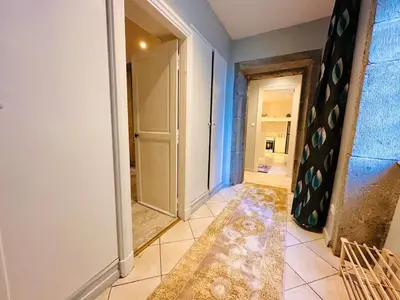 a hallway with a door and a tile floor at Le Refuge de Saint-Vincent - T2 Hyper Centre - Proche Gare in Carcassonne