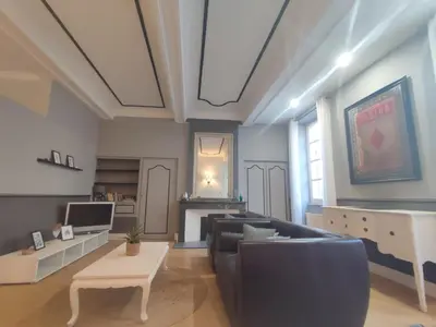 a living room with a couch and a table at Le Chartrand- Centre-ville- Séjour inoubliable! in Carcassonne