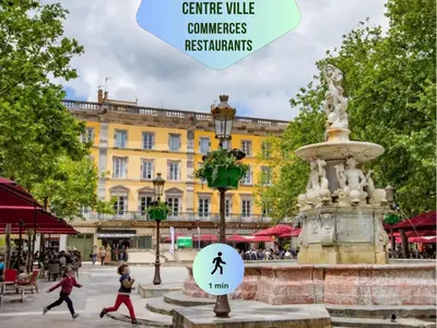 a city square with a fountain in front of a building at Le Chartrand- Centre-ville- Séjour inoubliable! in Carcassonne