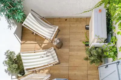 two lounge chairs on a patio with plants at Maison Charmante au coeur de la circulade-Patio-AB in Bram