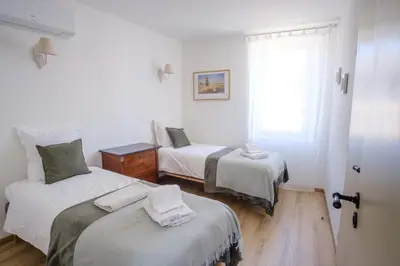 a room with two beds and a window at Maison Charmante au coeur de la circulade-Patio-AB in Bram