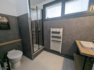 a bathroom with a toilet and a shower and a sink at Maison T4 110m² avec jardin clos, à 1500m de la plage - FR-1-797-60 in Port-la-Nouvelle