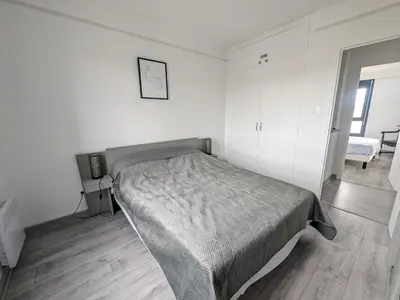 a bedroom with a bed in a white room at Maison T4 110m² avec jardin clos, à 1500m de la plage - FR-1-797-60 in Port-la-Nouvelle