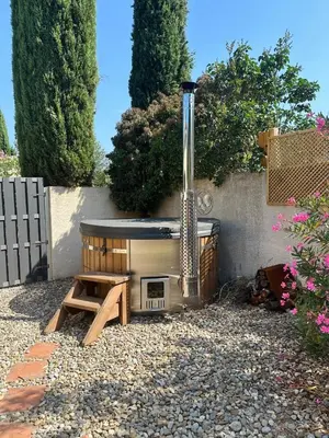 a backyard with a grill and a table and a bench at Carcassonne Lake & Beach, Pool villa in Carcassonne