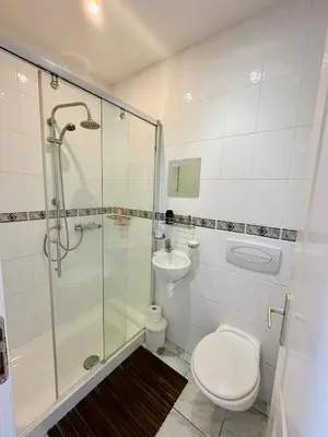 a bathroom with a shower and a toilet and a sink at Carcassonne Lake & Beach, Pool villa in Carcassonne