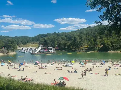 a group of people on a beach near a river at Carcassonne Lake & Beach, Pool villa in Carcassonne