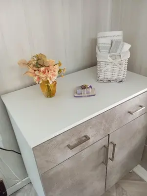 a white dresser with a vase of flowers on it at Villa Laurence in Lézignan-Corbières