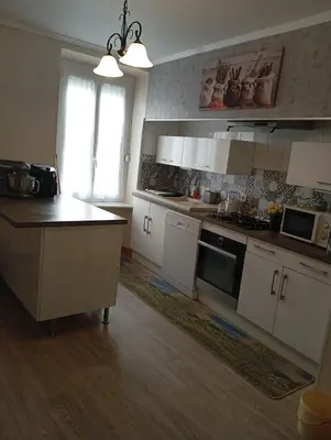 a kitchen with white cabinets and a counter top at Villa Laurence in Lézignan-Corbières