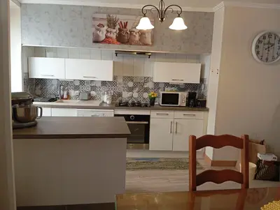 a kitchen with white cabinets and a counter top at Villa Laurence in Lézignan-Corbières