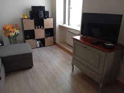 a living room with a flat screen tv on a dresser at Villa Laurence in Lézignan-Corbières