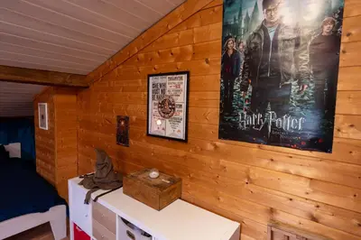 a room with a movie poster on a wooden wall at Chez Simon, au fil de l'eau in Revel