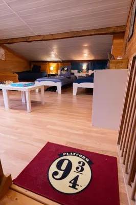 a living room with a red rug on the floor at Chez Simon, au fil de l'eau in Revel