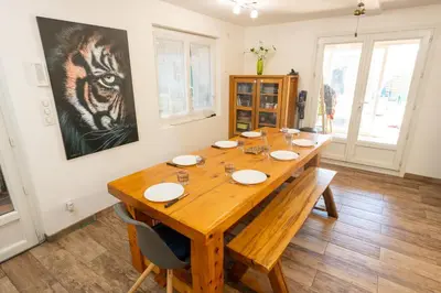 a wooden table in a room with a painting on the wall at Chez Simon, au fil de l'eau in Revel
