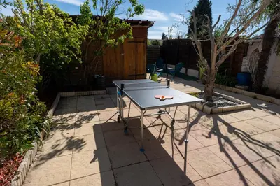 a ping pong table sitting on a patio at Chez Simon, au fil de l'eau in Revel