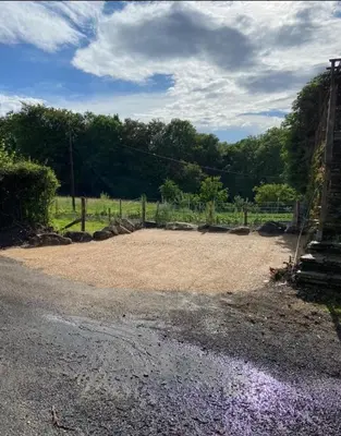 a dirt field with a fence and purple flowers at Beau Gîte de Campagne 3 épis in Les Martys