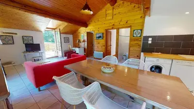 a dining room with a table and chairs in a room at Beau Gîte de Campagne 3 épis in Les Martys