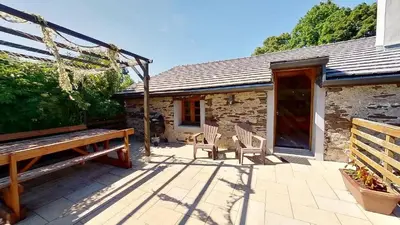 a patio with two chairs and a bench at Beau Gîte de Campagne 3 épis in Les Martys