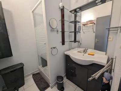a bathroom with a sink and a mirror at Charmant T2 pour 4 pers à 100m de la plage avec balcon - FR-1-797-61 in Port-la-Nouvelle