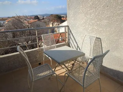three chairs and a table on a balcony at Charmant T2 pour 4 pers à 100m de la plage avec balcon - FR-1-797-61 in Port-la-Nouvelle