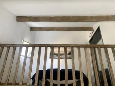 a staircase in a room with wooden beams at Maison in Port-la-Nouvelle
