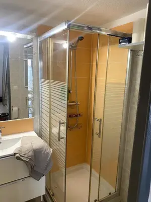 a shower with a glass door in a bathroom at Maison in Port-la-Nouvelle