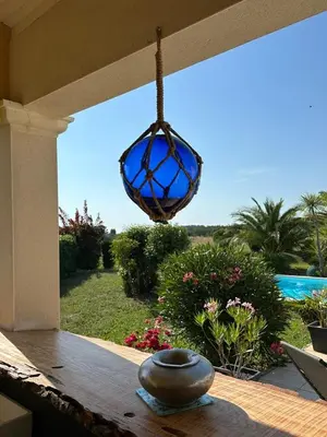 a blue glass chandelier hanging from a porch at Villa T6 d'exception entre Toulouse et Carcassonne , Vue sur les Pyrénées in Trébons-sur-la-Grasse