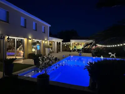 a swimming pool with blue lighting in front of a house at Villa T6 d'exception entre Toulouse et Carcassonne , Vue sur les Pyrénées in Trébons-sur-la-Grasse