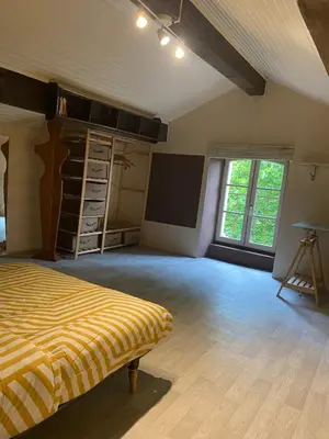 an empty room with a bed and a window at Maison viticole dans le Sud de la France avec grand piscine in Moussan