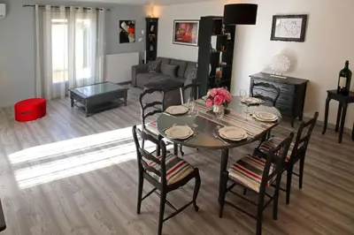 a living room with a dining room table and chairs at Magnifique villa avec piscine in Carcassonne