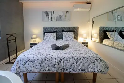 a bedroom with a bed with two pillows on it at Magnifique villa avec piscine in Carcassonne