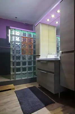 a bathroom with a sink and a glass wall at Magnifique villa avec piscine in Carcassonne