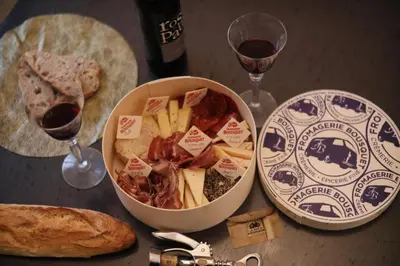 a table with a bowl of food and two glasses of wine at Magnifique villa avec piscine in Carcassonne