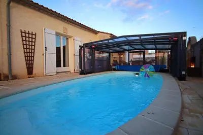 a large swimming pool with a metal cover over it at Magnifique villa avec piscine in Carcassonne