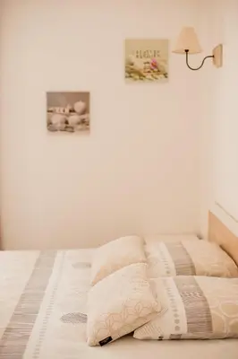 a bed with two pillows on it in a bedroom at Villa Serenita in Villemoustaussou