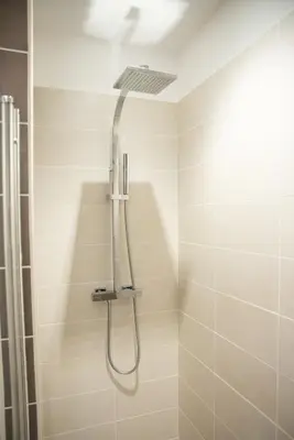 a shower with a shower head in a bathroom at Villa Serenita in Villemoustaussou