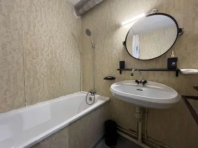 a bathroom with a sink and a tub and a mirror at Appartement rénové avec vue marina Gruissan GN140-1033 in Gruissan