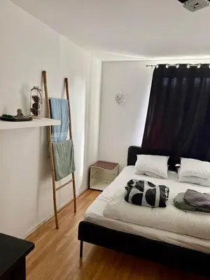 a bedroom with a bed with a black and white pillow at Maison au coeur du Sidobre in Saint-Salvy-de-la-Balme