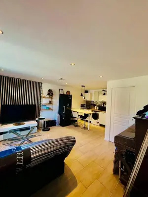 a living room with a couch and a table at Maison au coeur du Sidobre in Saint-Salvy-de-la-Balme