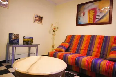 a bedroom with a large bed and a table with a lamp at Lou Vidal - 6 Pers 5 minutes plage in Fitou