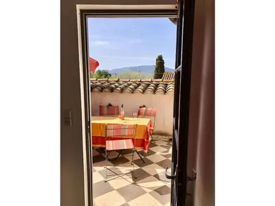 a room with a table and a view out a door at Moliere - la maison Comfortable holiday residence in Ferrals-lès-Corbières