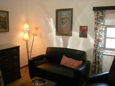 a living room with a leather couch and a lamp at Moliere - la maison Comfortable holiday residence in Ferrals-lès-Corbières