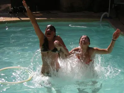 two people are playing in a swimming pool at Maison de Maitre Comfortable holiday residence in Ferrals-lès-Corbières